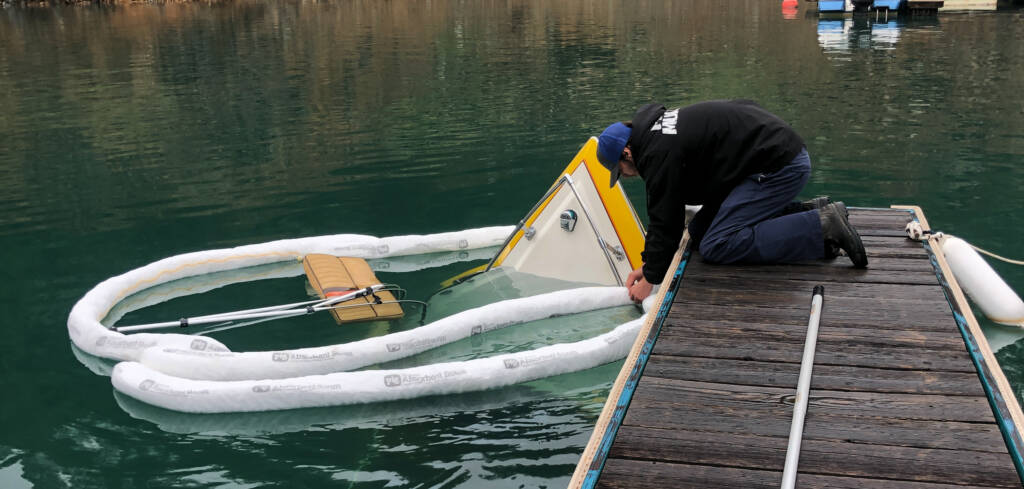 Boat recovery of a sunken boat in a slip from heavy rain