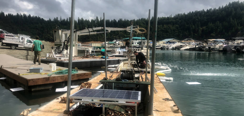 Boat recovery with diver empting water to raise the sinking vessel