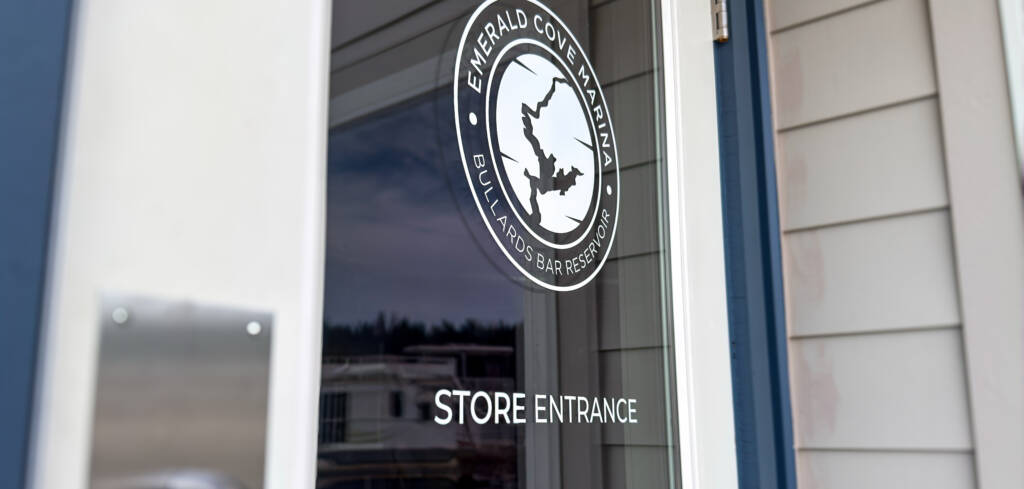 floating store entrance door with emerald cove marina logo on the door