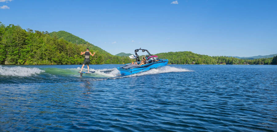 T220 malibu axis boat on lake showing wakesurfing activities