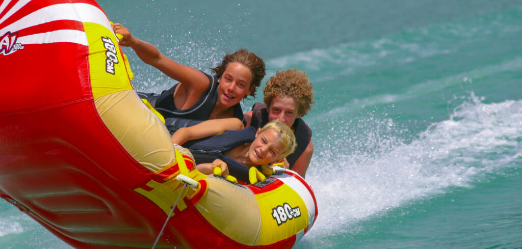 tubing water sports tubing on bullards bar reservoir of people having fun in hard turn on the clear waters